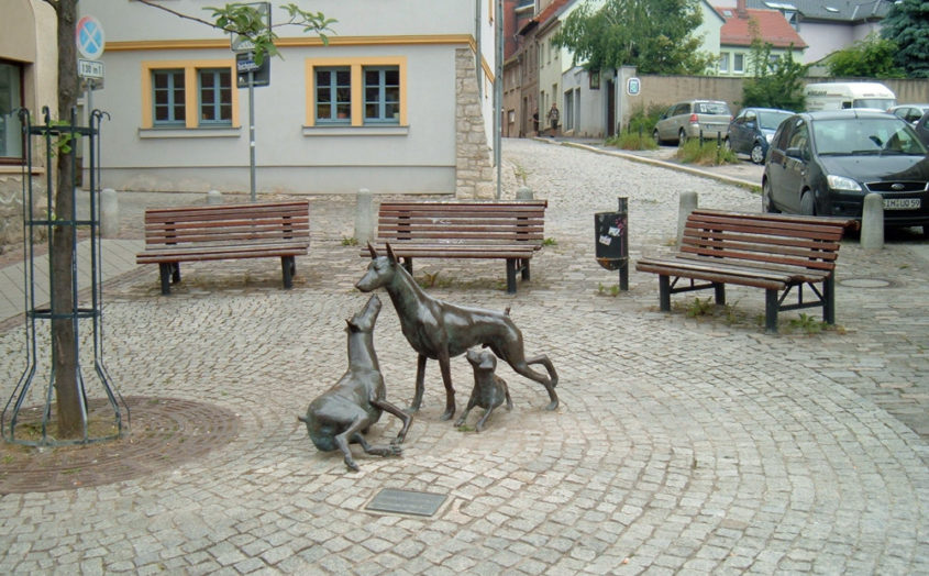 bronze doberman statue monument in europe showing 3 dogs